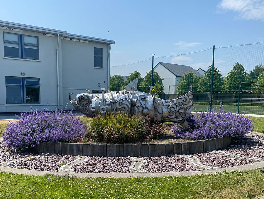 Fish sculpture in front of school building