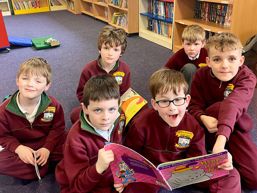 Students listening to a story at the Infant After School Club